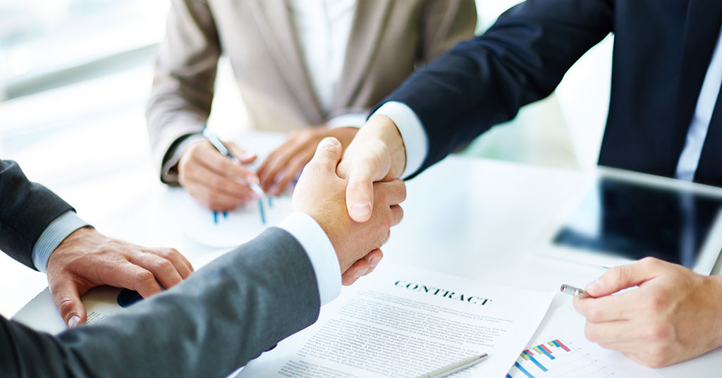 Business team reviewing commercial contracts during a company growth planning meeting